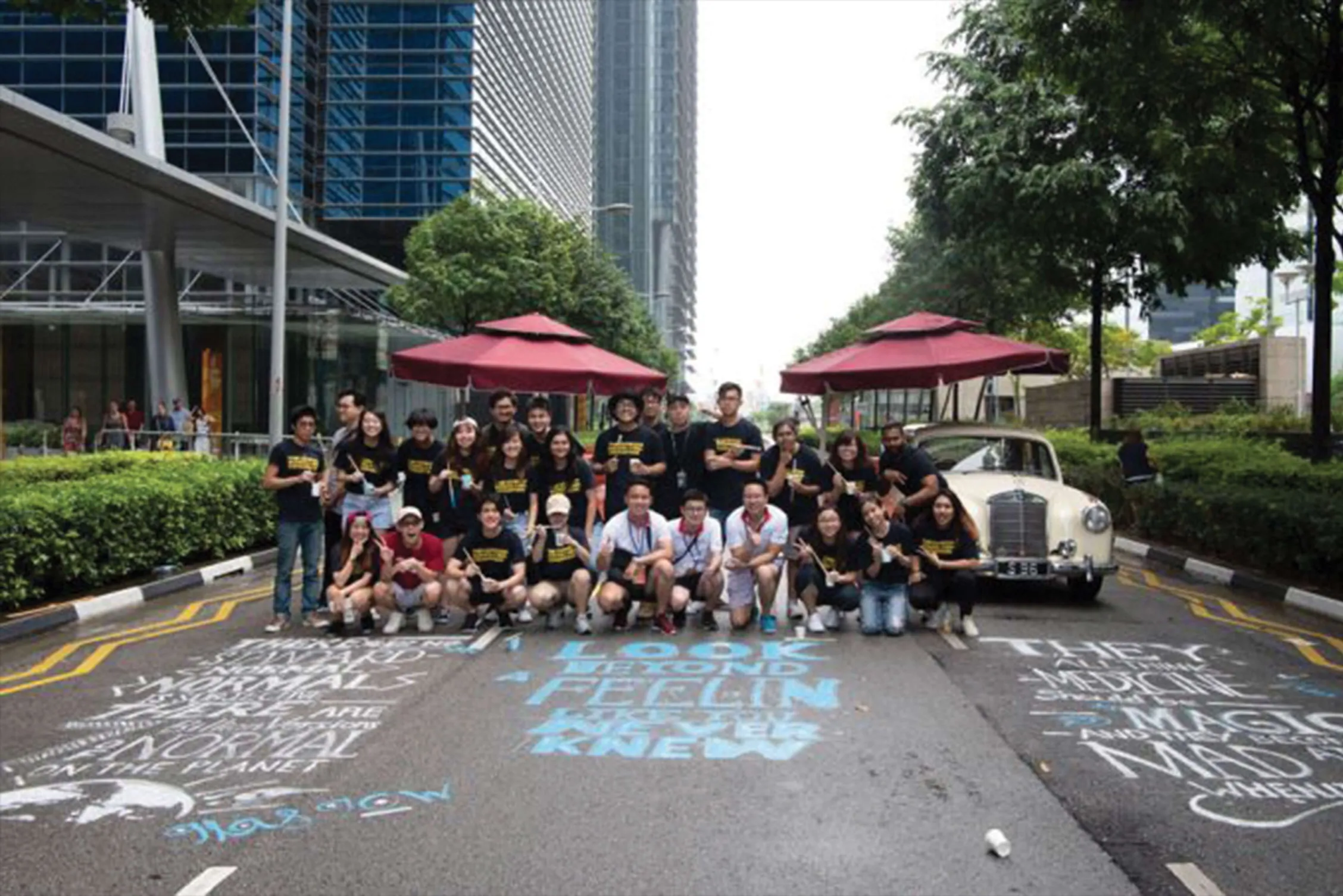 Group of students and staff behind the finished chalk murals